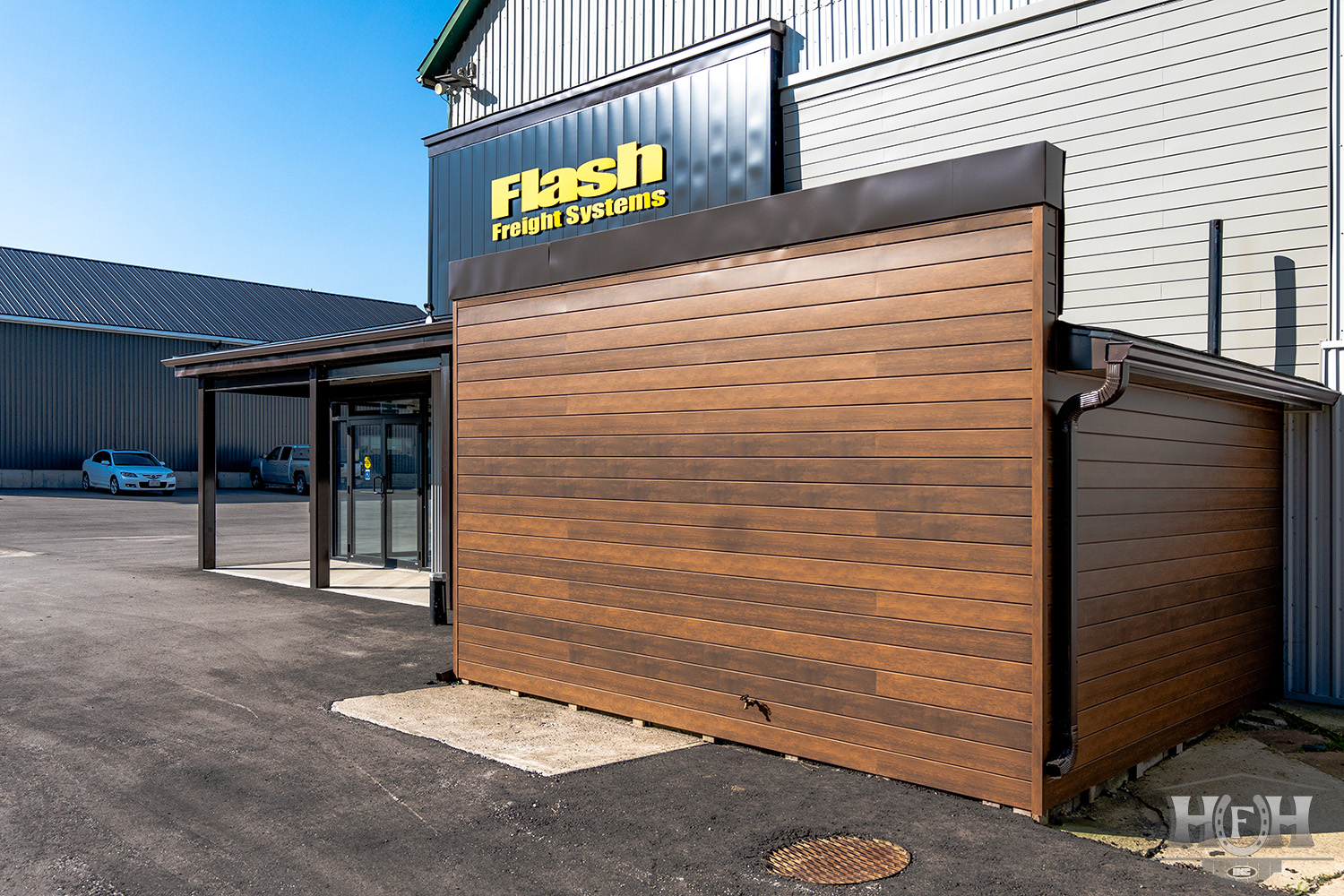 Exterior entrance with faux wooden siding