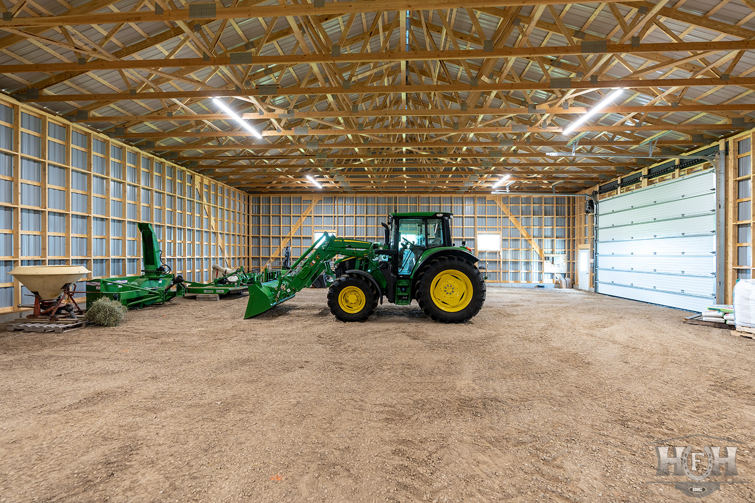 Interior of custom shop with large green tractor