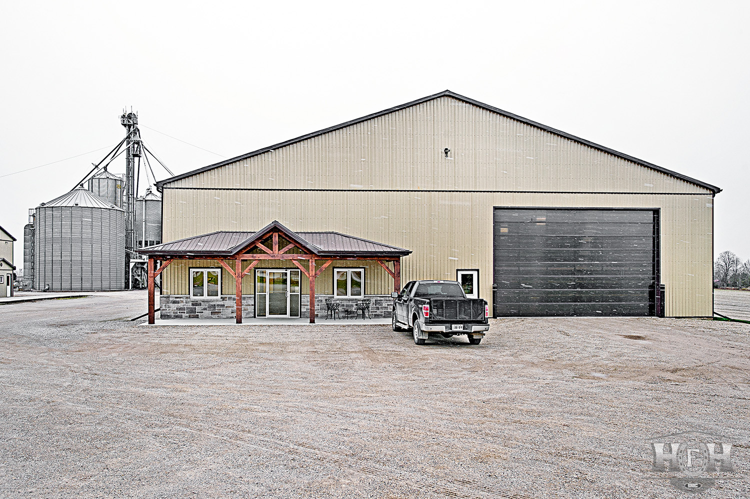 Front entrance of large custom shop with truck parked