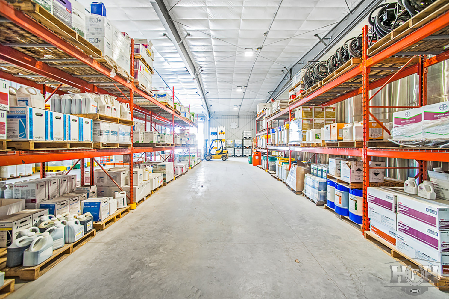 Interior commercial chemical storage with shelves stacked with chemicals