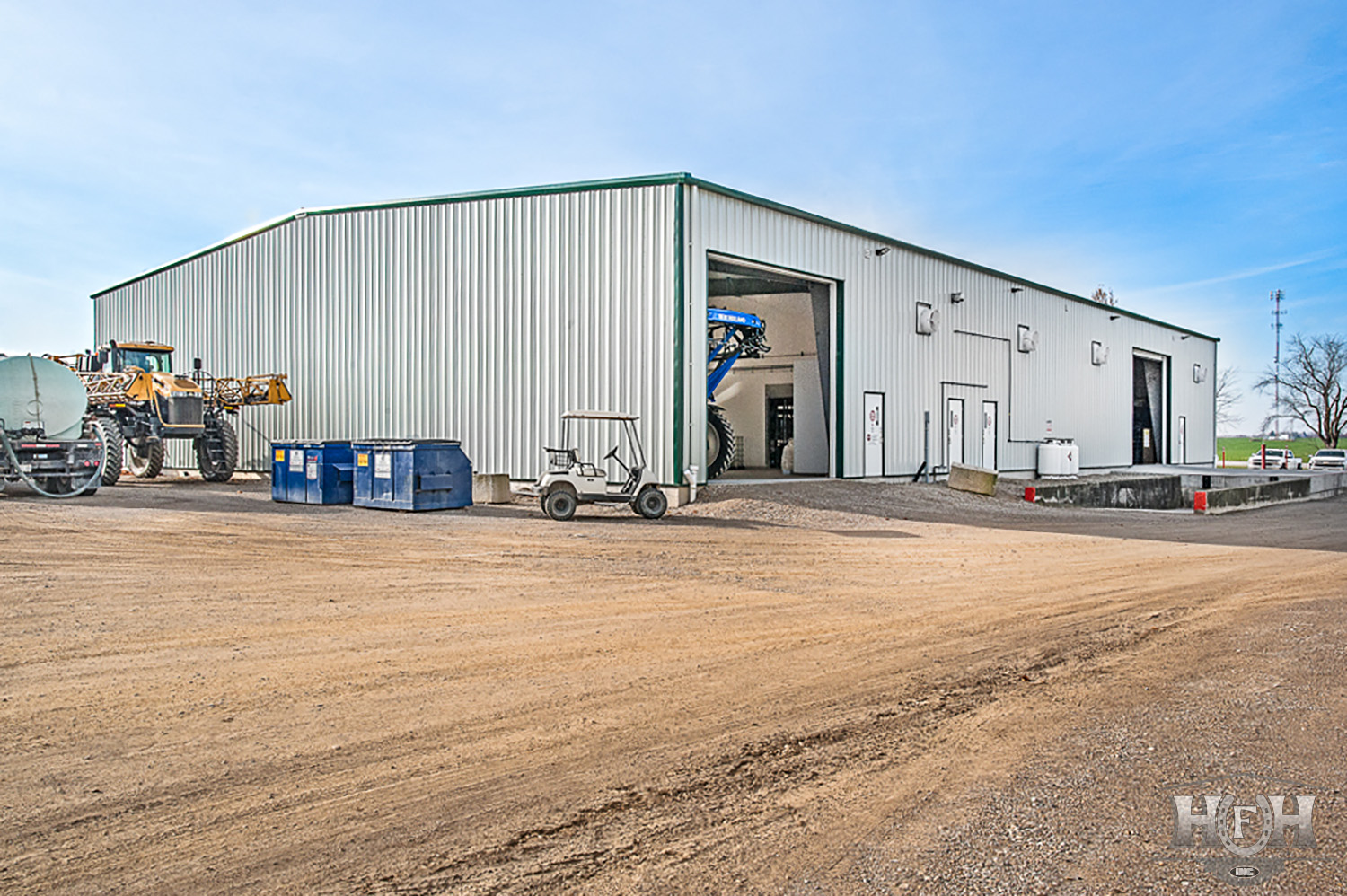 Exterior chemical storage building with golf cart and various machinery