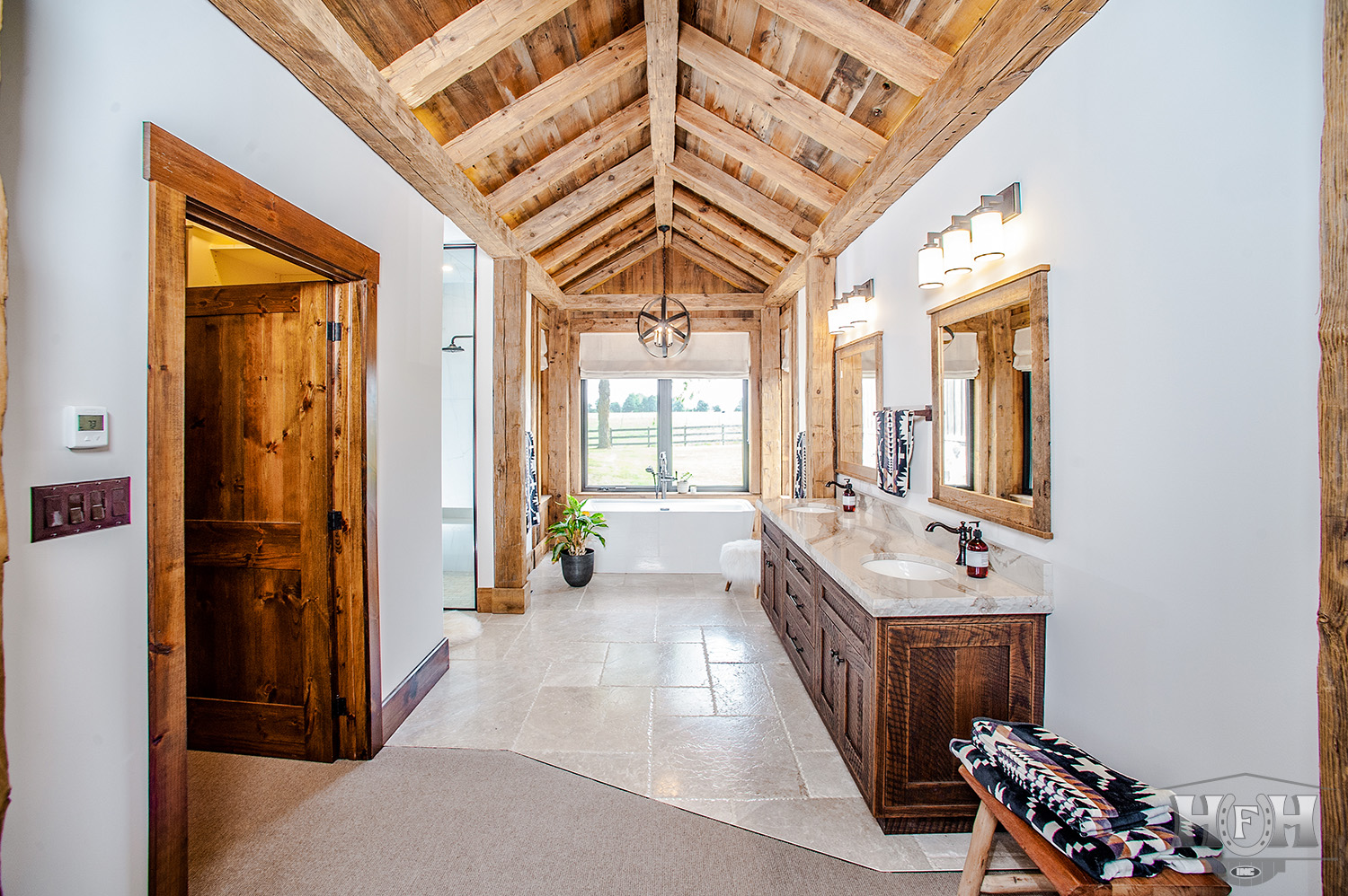 Interior master bathroom with double sink vanity and large window